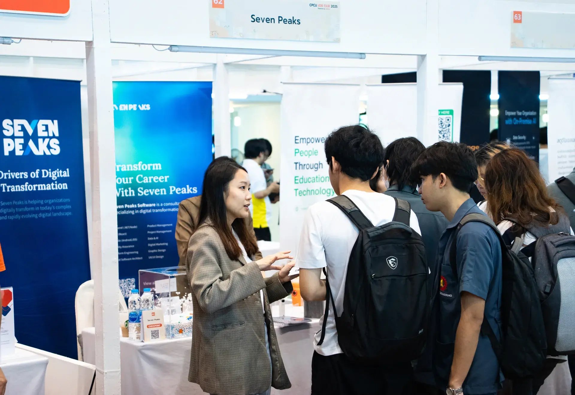 Seven Peaks representative speaking with students at the company booth