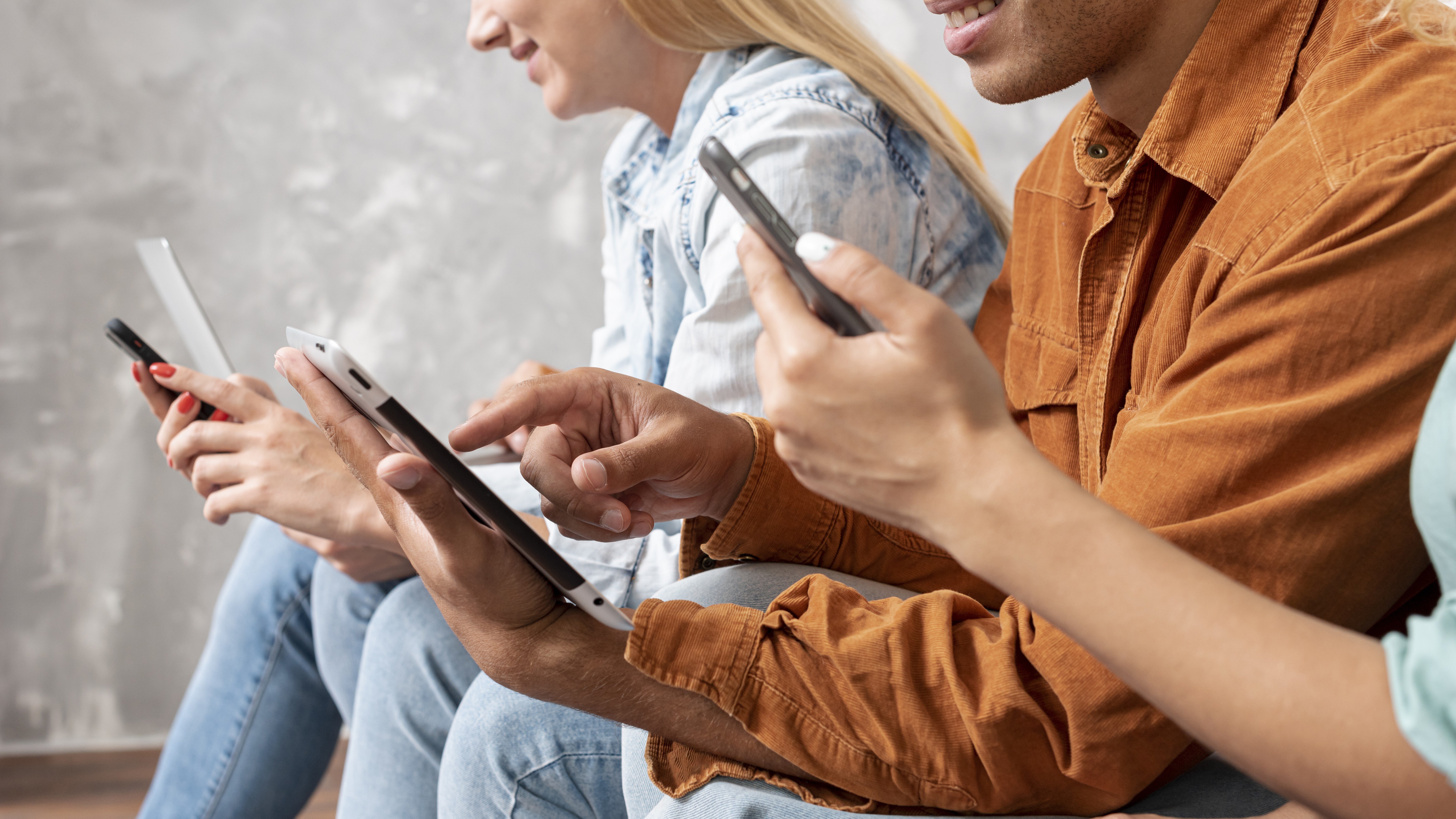 close-up-friends-checking-their-phones-1
